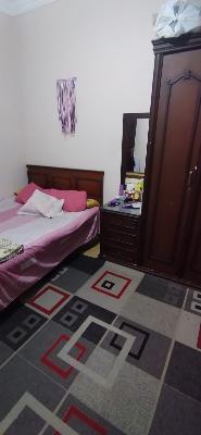 Bedroom  with cupboard and rug